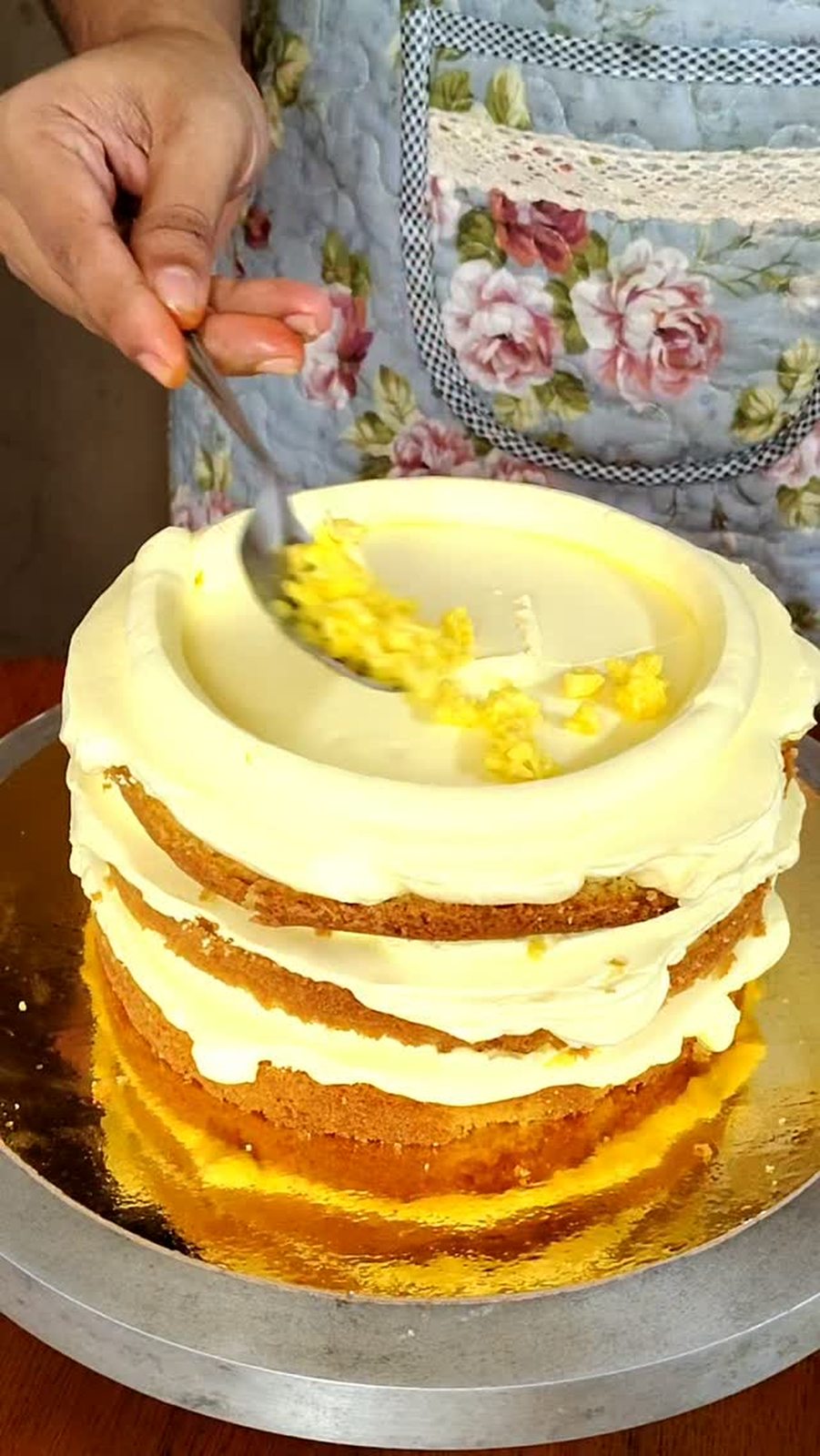 Orange cake being frosted