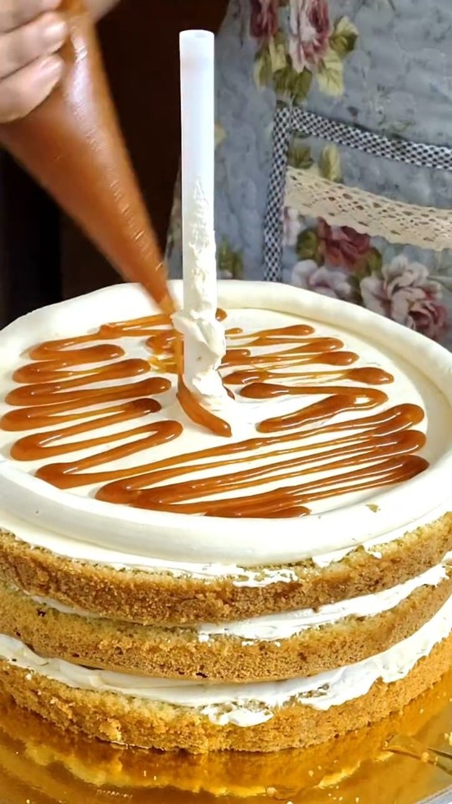Caramel being drizzled over a naked cake